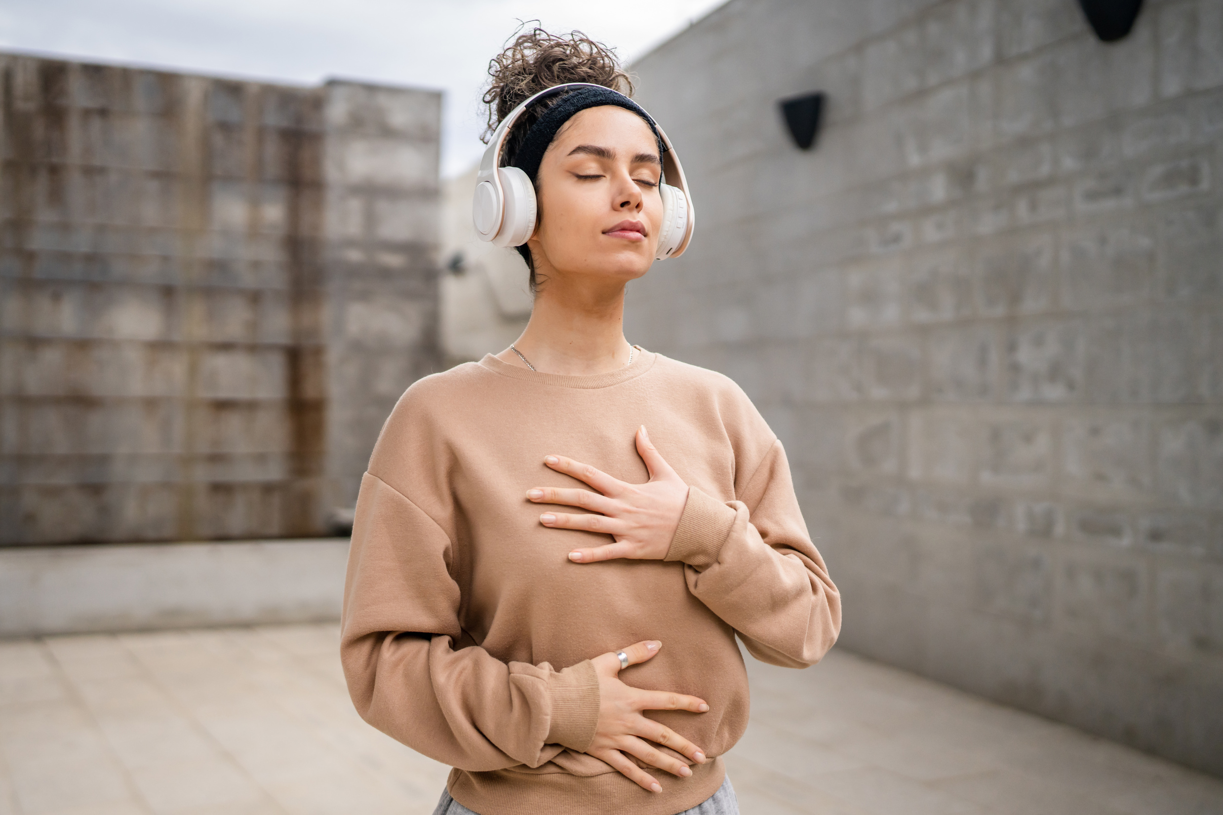 woman caucasian female using headphones for online guided meditation